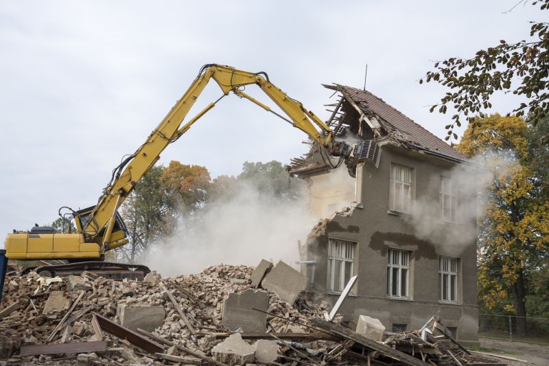 Excavator Demolishing a Building